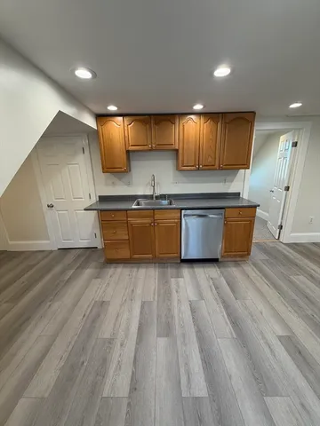 a large kitchen with stainless steel appliances granite countertop a large stove a sink and a microwave