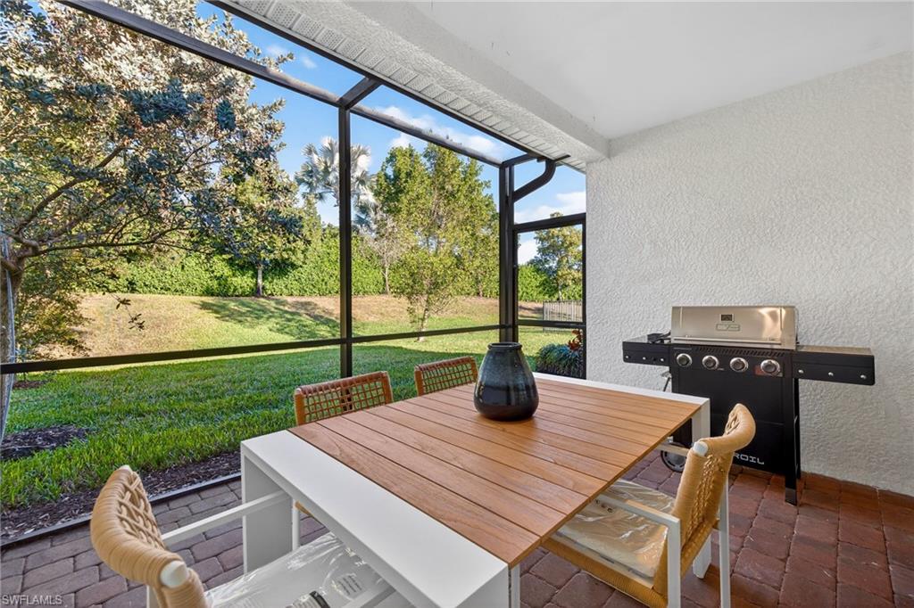 14567 Edgewater Circle Naples, FL 34114 - Photo 27 of 44 a view of an outdoor dining space with a table and chairs in the patio