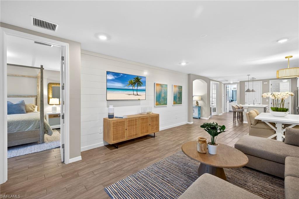 14567 Edgewater Circle Naples, FL 34114 - Photo 3 of 44 a living room with furniture and wooden floor