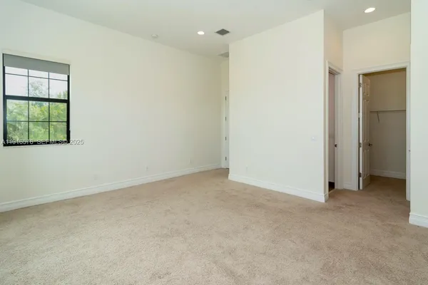 an empty room with windows and entrance