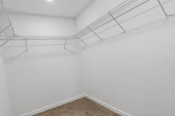 a bathroom with a toilet sink vanity and mirror
