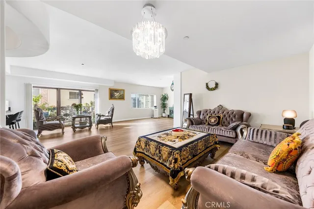 a living room with furniture and a chandelier