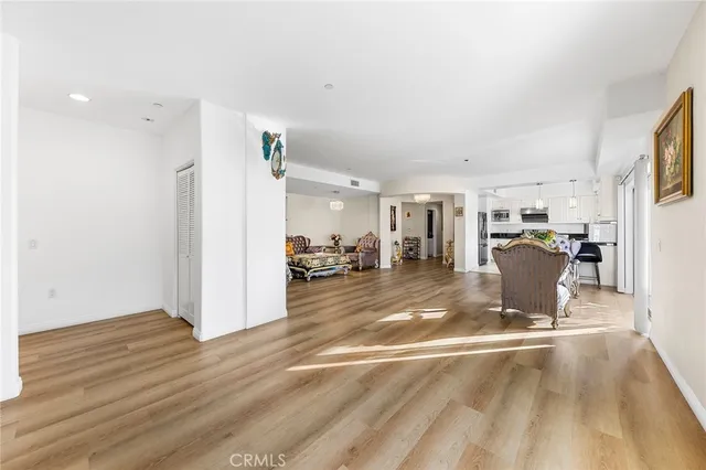 a view of a living room and a livingroom with furniture wooden floor and a fireplace