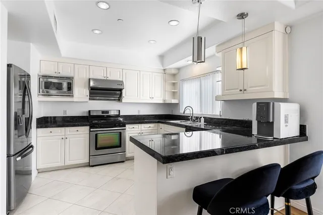 a kitchen with stainless steel appliances granite countertop a sink and stove top oven