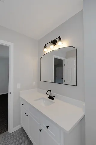 a bathroom with a sink and a mirror
