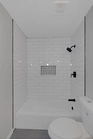a bathroom with a toilet and shower