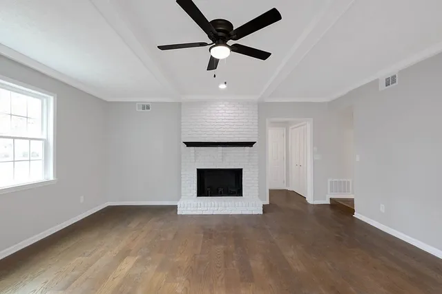wooden floor fireplace and windows in a room