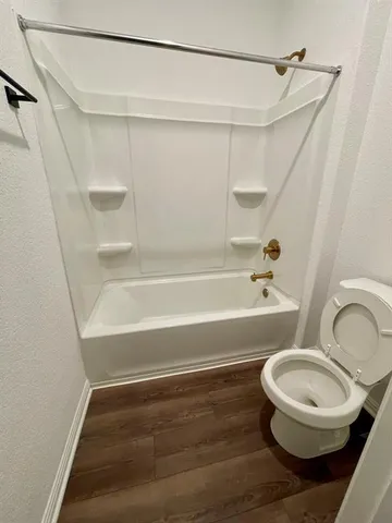 a bathroom with a toilet and a bathtub