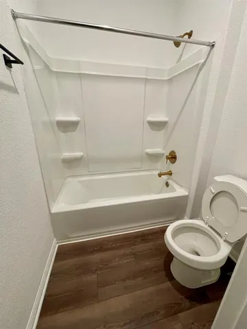 a bathroom with a toilet and a bathtub