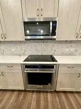 a stove top oven sitting inside of a kitchen