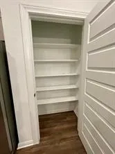 a view of walk in closet with empty racks