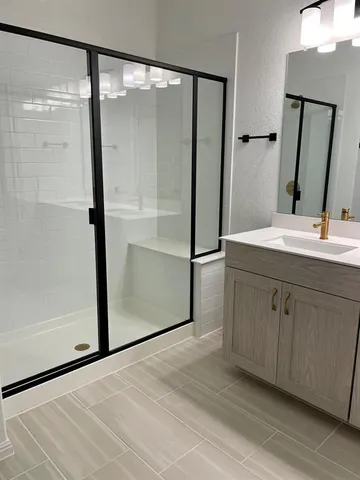 a bathroom with a double vanity sink and mirror