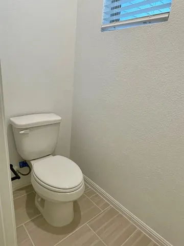 a white toilet sitting next to a shower