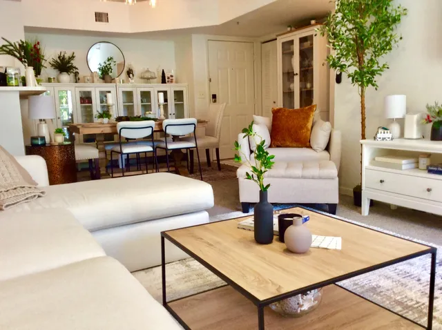 a living room with couches a dining table and chairs with outer view