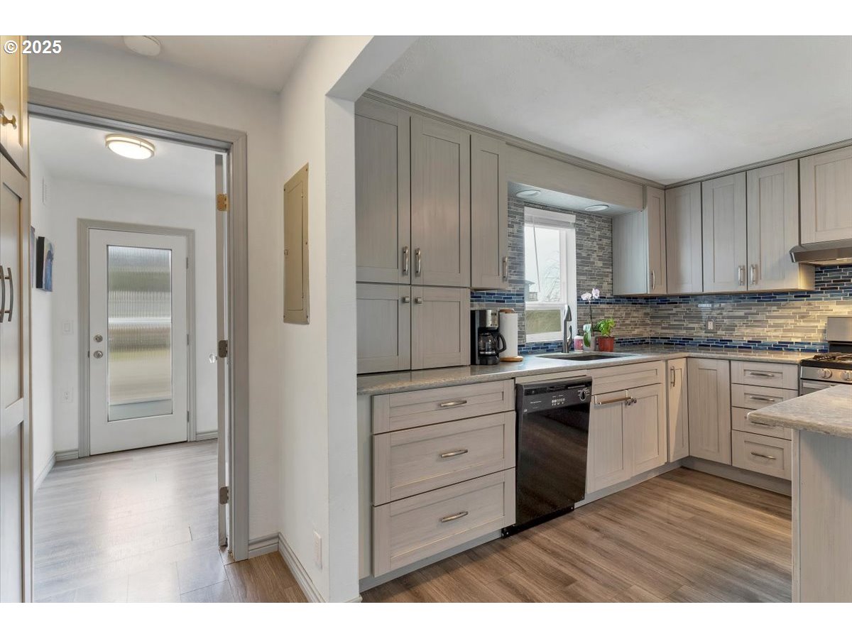 60 Raven Lane Depoe Bay, OR 97341 - Photo 20 of 43 a kitchen with granite countertop white cabinets and white appliances