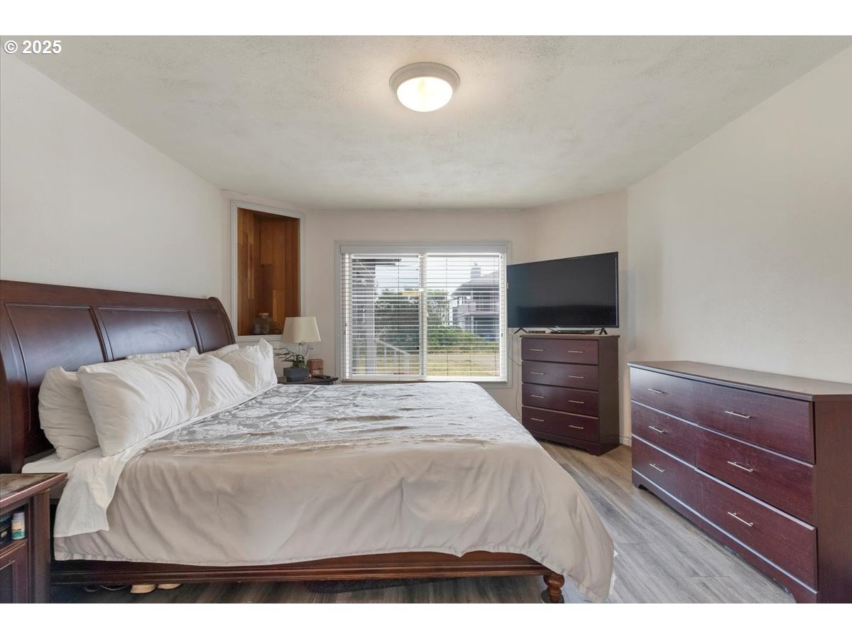 60 Raven Lane Depoe Bay, OR 97341 - Photo 24 of 43 a bedroom with a bed and a television