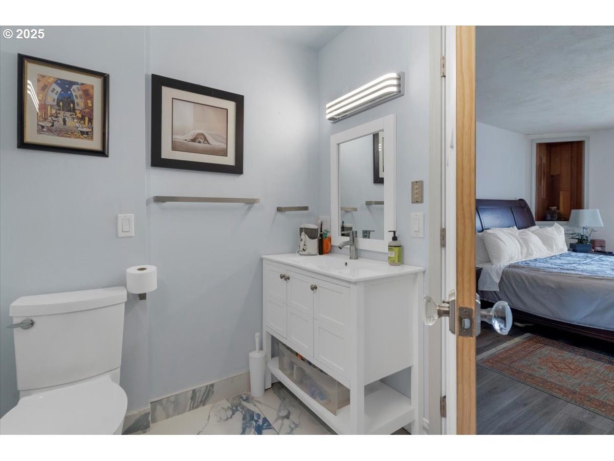 60 Raven Lane Depoe Bay, OR 97341 - Photo 25 of 43 a en suite bathroom with a toilet sink and mirror