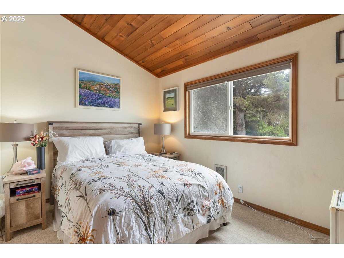 60 Raven Lane Depoe Bay, OR 97341 - Photo 32 of 43 a bedroom with a large bed and a window