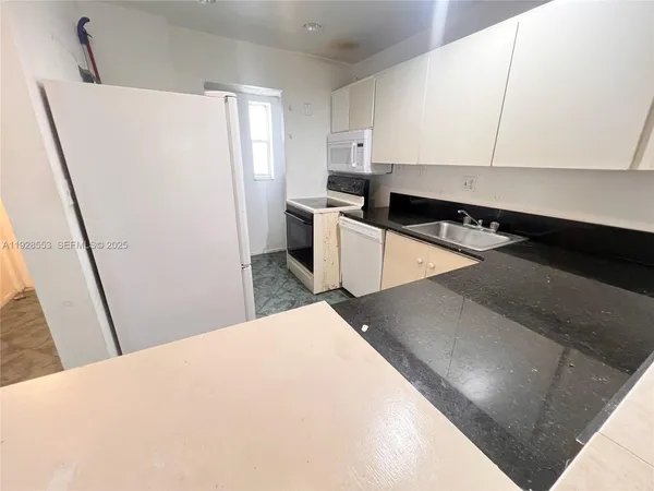 a kitchen with a sink and a refrigerator