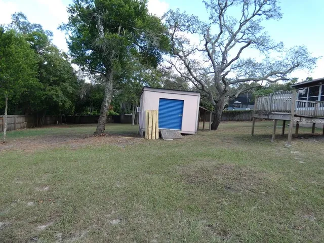 a kitchen with stainless steel appliances kitchen island granite countertop a sink refrigerator and microwave