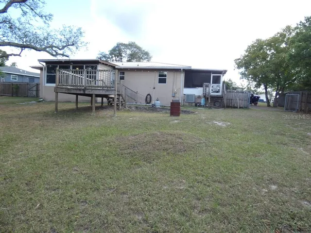 a view of a dining room with furniture and a chandelier