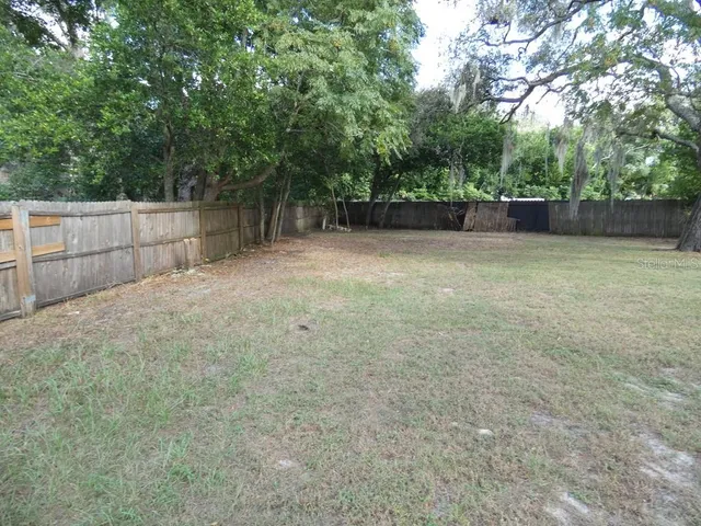 a living room with furniture a large mirror and a chandelier
