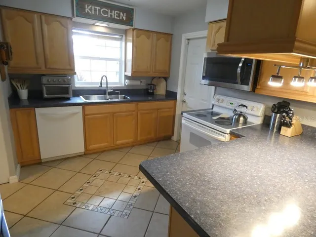 a living room with furniture a large window and a flat screen tv