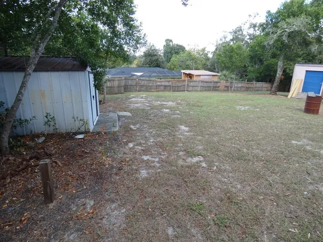 a view of a backyard with large trees