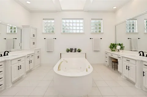 a bathroom with a sink a vanity and a bathtub