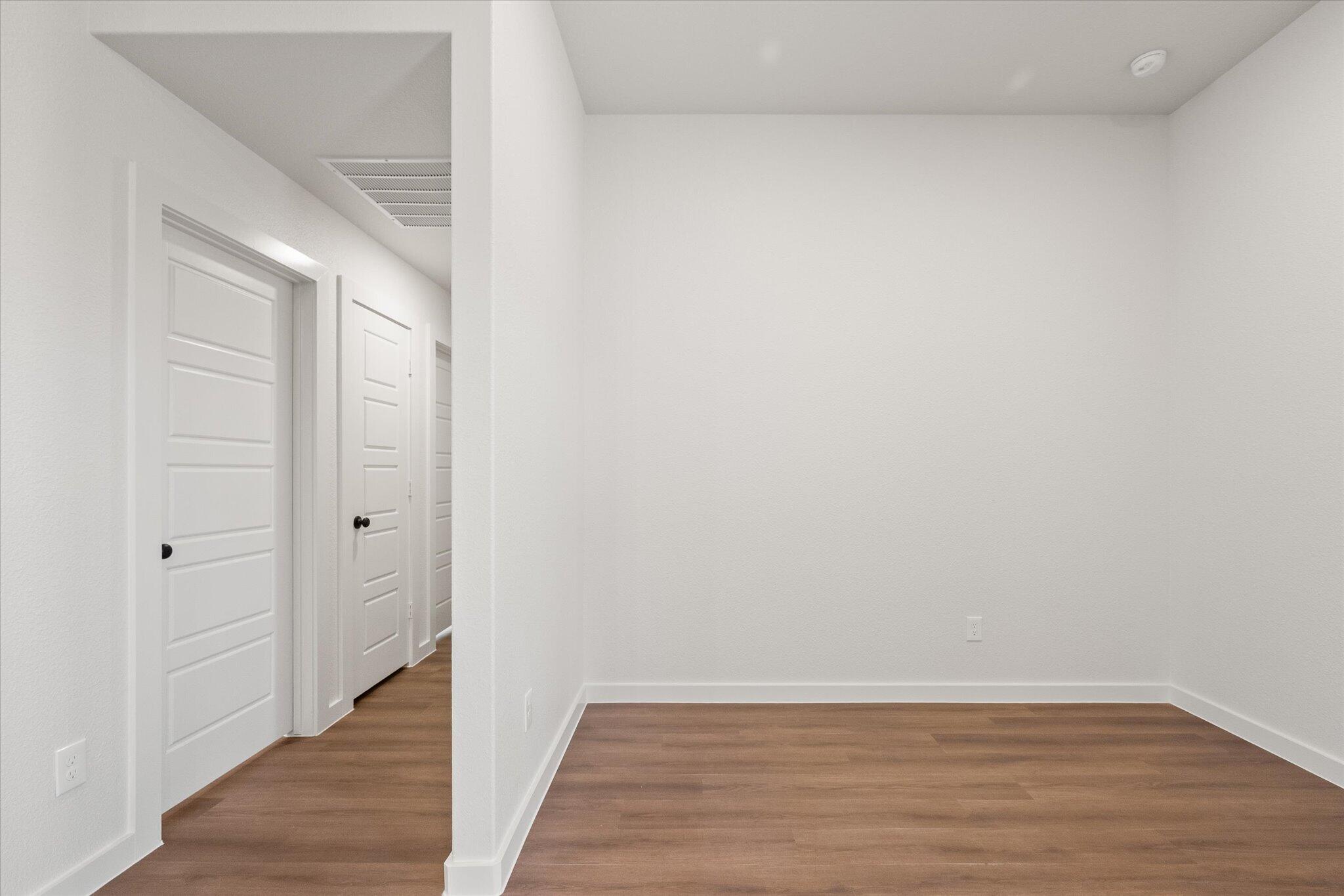 7111 14th Street Lubbock, TX 79416 - Photo 15 of 25 a view of an empty room with wooden floor