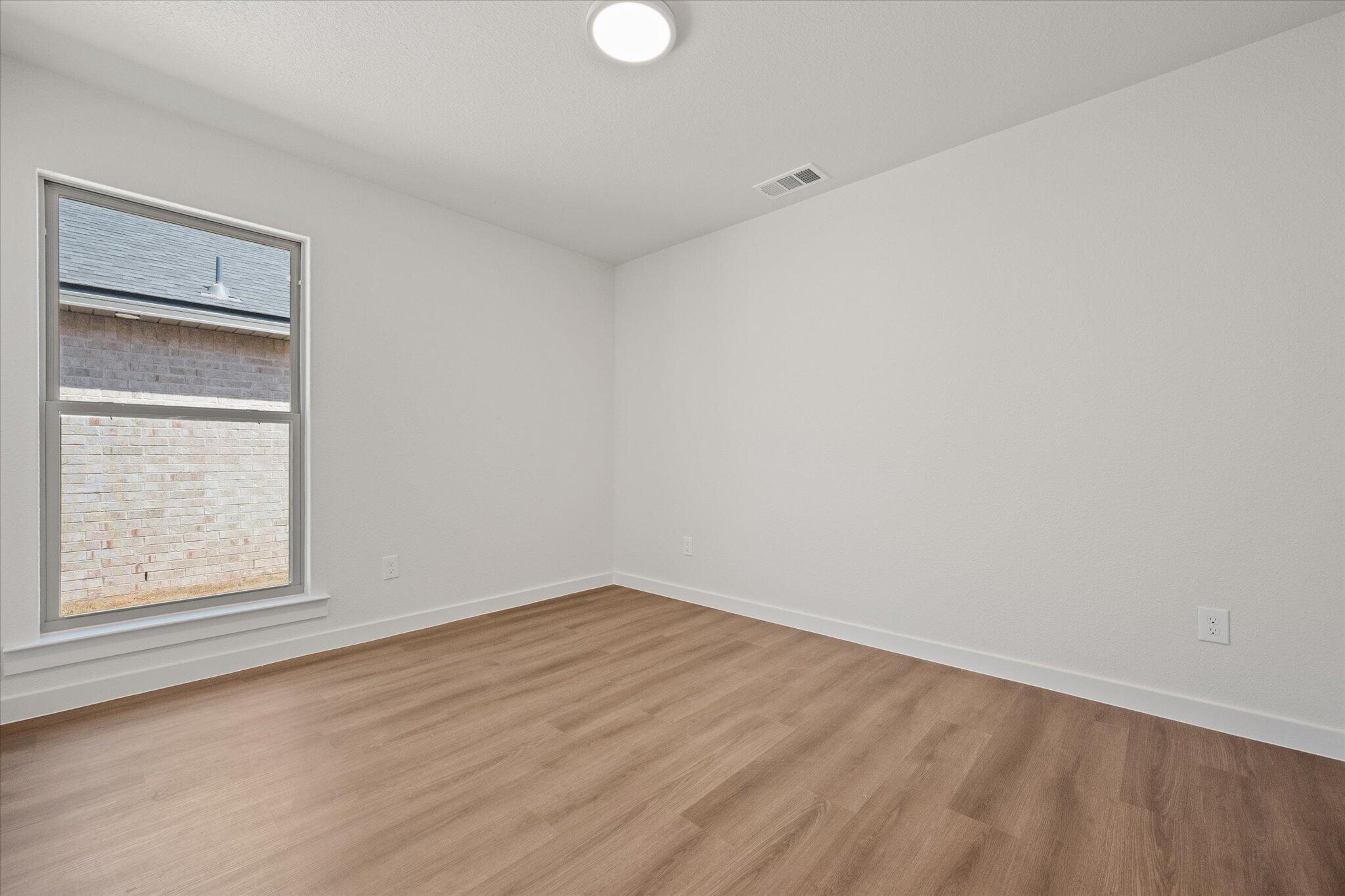 7111 14th Street Lubbock, TX 79416 - Photo 21 of 25 an empty room with a window