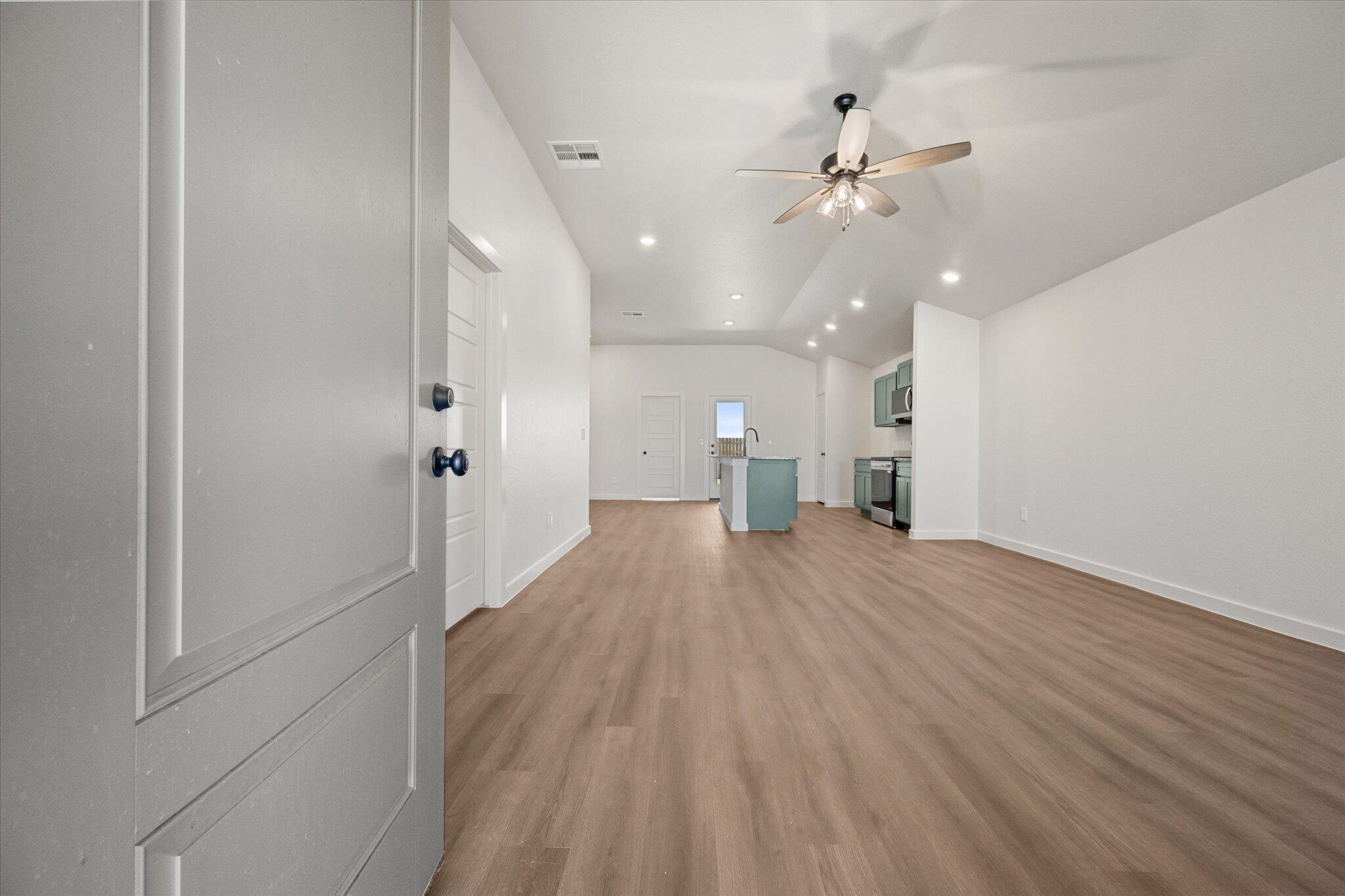 7111 14th Street Lubbock, TX 79416 - Photo 3 of 25 wooden floor in an empty room with a window