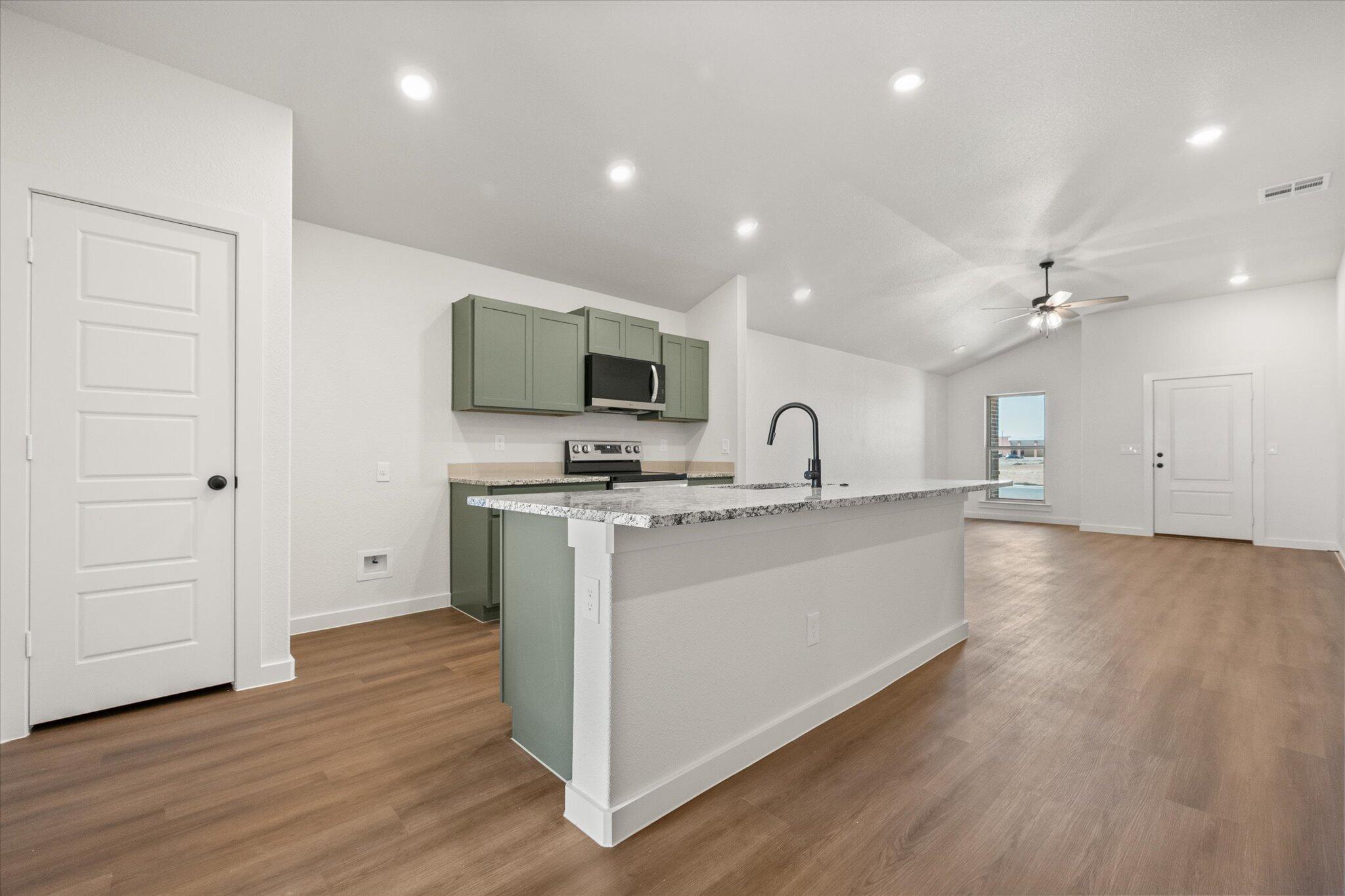 7111 14th Street Lubbock, TX 79416 - Photo 10 of 25 a view of kitchen with sink and wooden floor