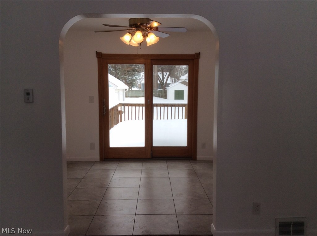 Dining room w/ new tile floor. Sliders to deck.