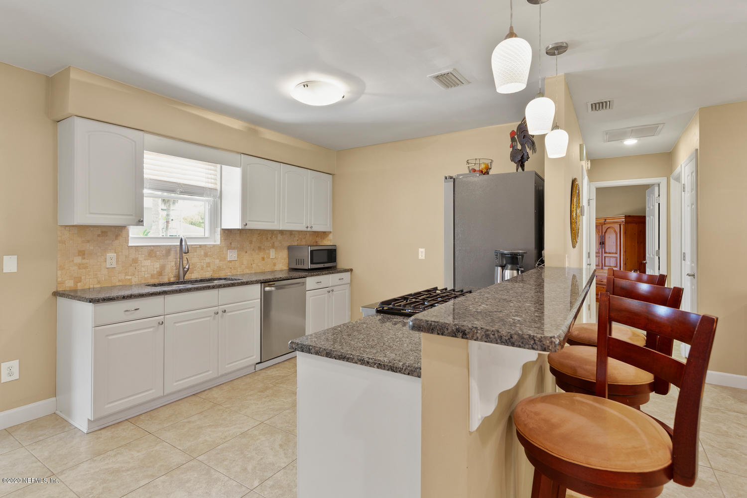 4111 San Pablo Road South Jacksonville, FL 32250 - Photo 8 of 46 a kitchen with stainless steel appliances granite countertop a sink a stove and a refrigerator