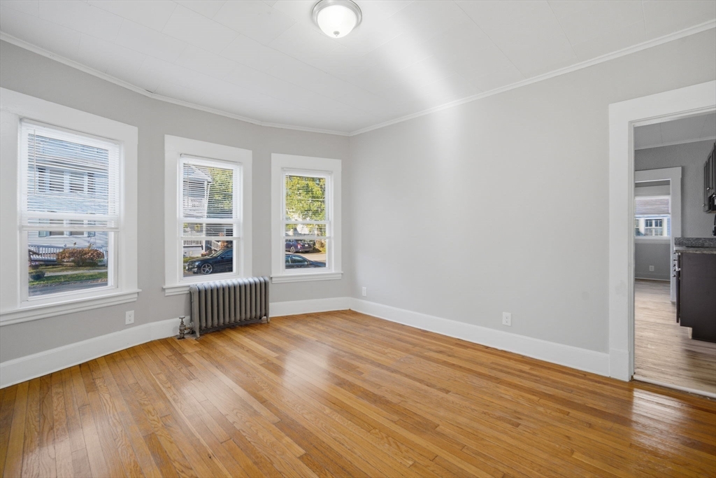 35-37 Whittier Street Springfield, MA 01108 - Photo 11 of 24 wooden floor in an empty room with a window