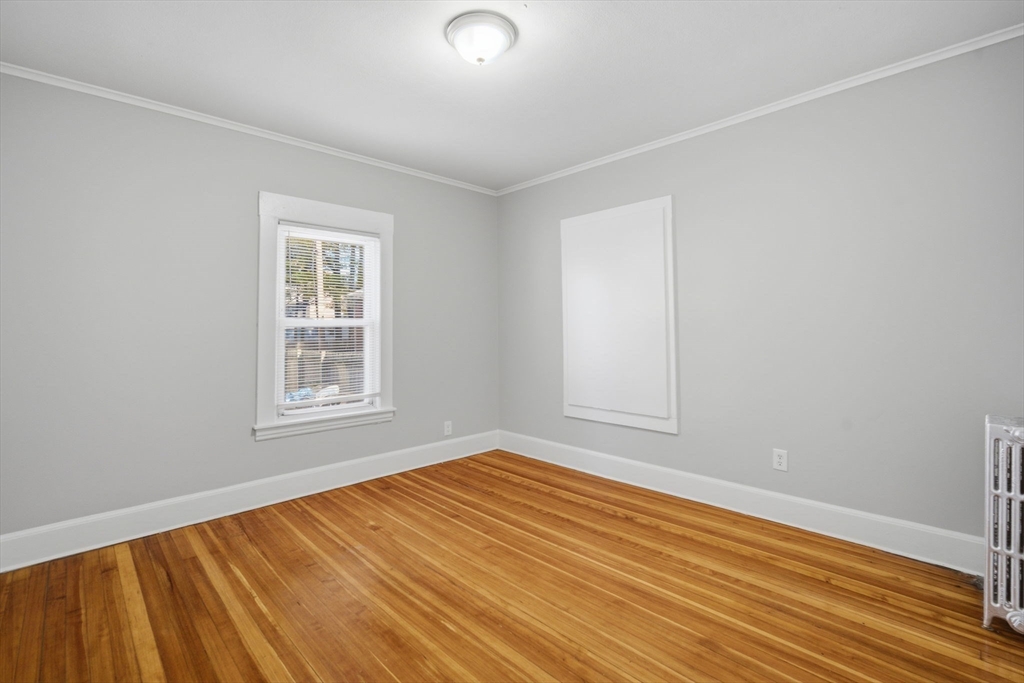 35-37 Whittier Street Springfield, MA 01108 - Photo 16 of 24 an empty room with wooden floor and windows