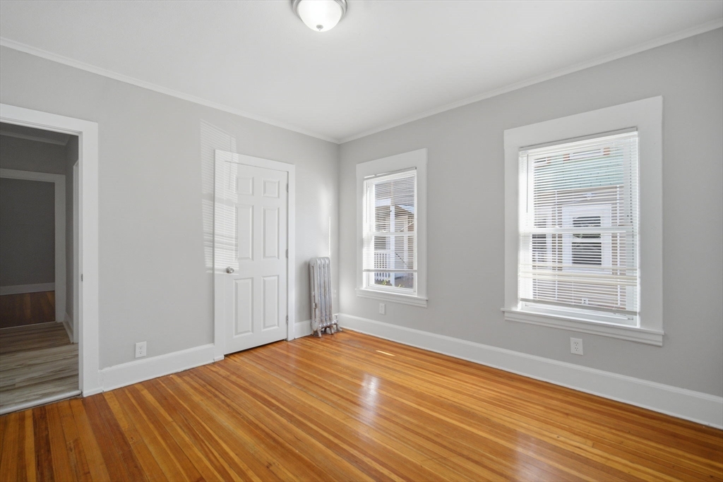 35-37 Whittier Street Springfield, MA 01108 - Photo 18 of 24 a view of empty room with wooden floor and fan