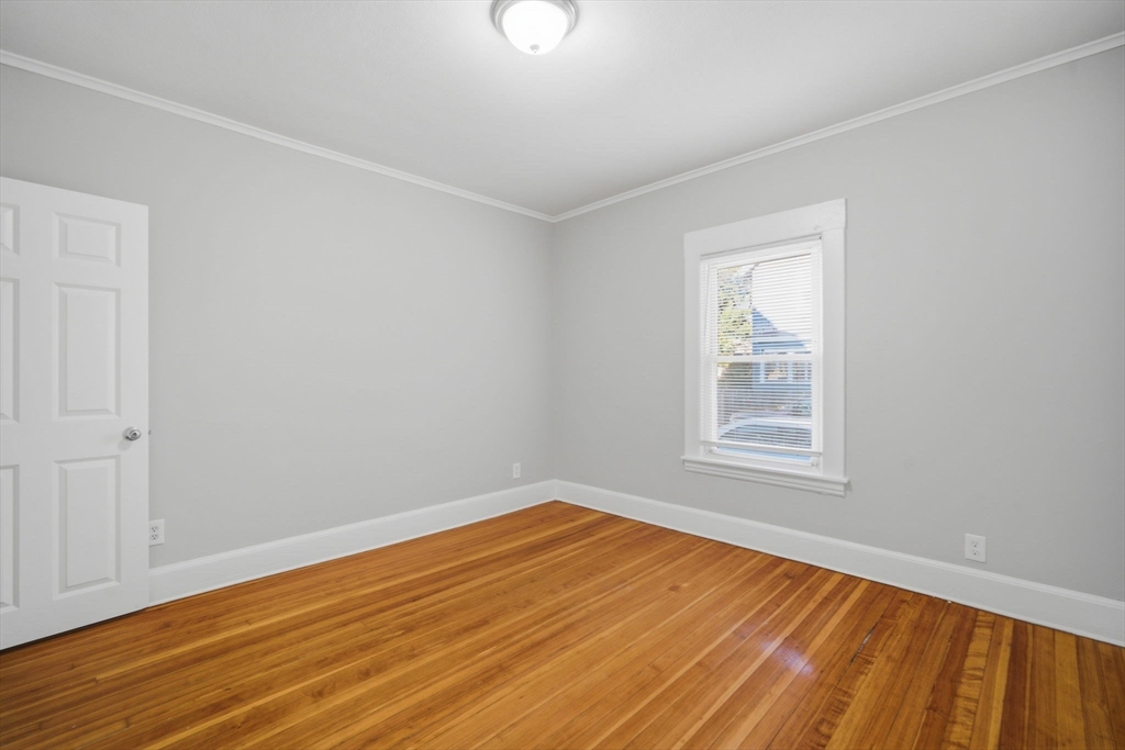 35-37 Whittier Street Springfield, MA 01108 - Photo 19 of 24 a view of an empty room with wooden floor and a window