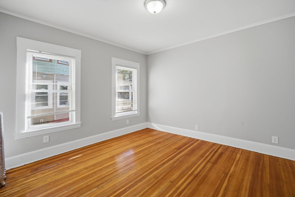 35-37 Whittier Street Springfield, MA 01108 - Photo 20 of 24 a view of empty room with wooden floor and fan
