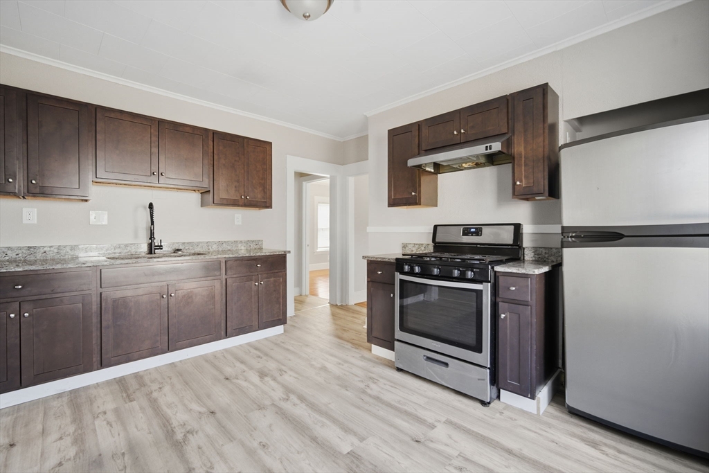 35-37 Whittier Street Springfield, MA 01108 - Photo 6 of 24 a kitchen with stainless steel appliances a stove a sink and a refrigerator