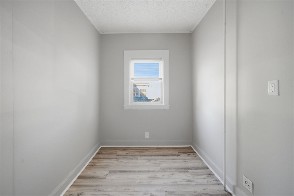 35-37 Whittier Street Springfield, MA 01108 - Photo 10 of 24 a view of an empty room with wooden floor and a window