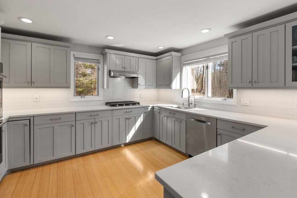 3 Parsons Way Natick, MA 01760 - Photo 3 of 32 a kitchen with kitchen island granite countertop a sink cabinets and window