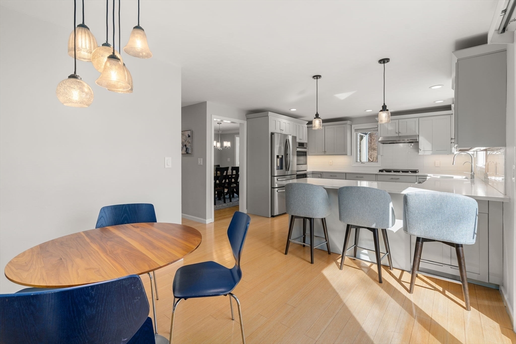 3 Parsons Way Natick, MA 01760 - Photo 6 of 32 a kitchen with stainless steel appliances kitchen island granite countertop a table chairs and a refrigerator