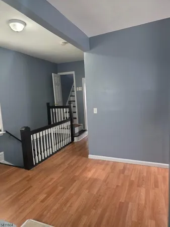 a view of a room with wooden floor