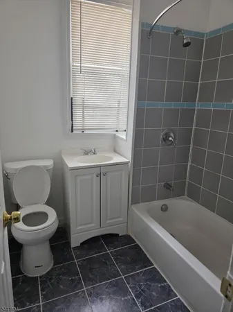 a bathroom with a bathtub toilet and sink