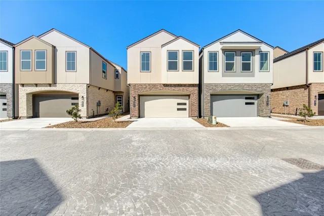 a view of a white house with large windows