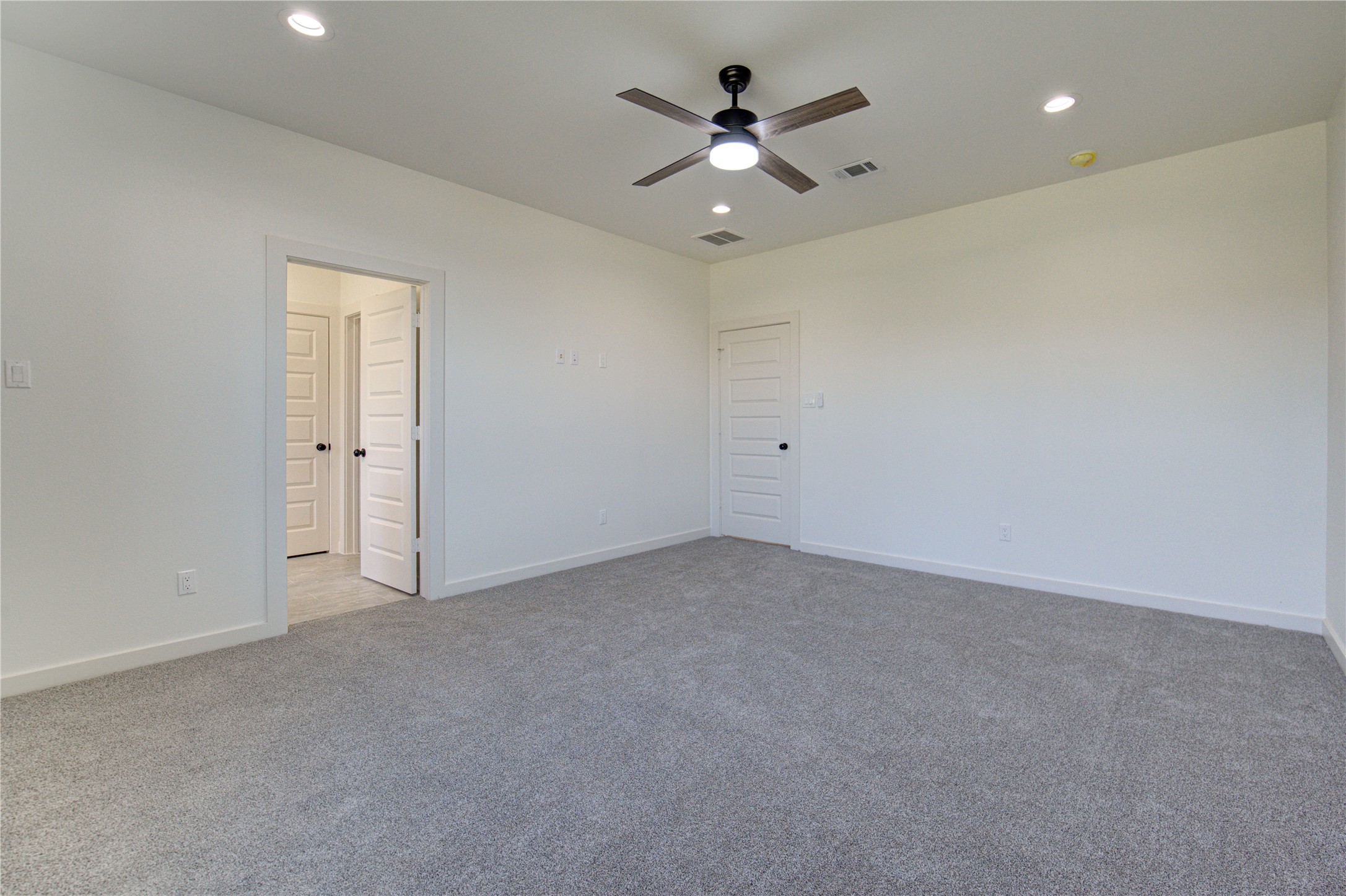 2920 El Fenice Lane Houston, TX 77057 - Photo 15 of 42 an empty room with a chandelier fan and windows