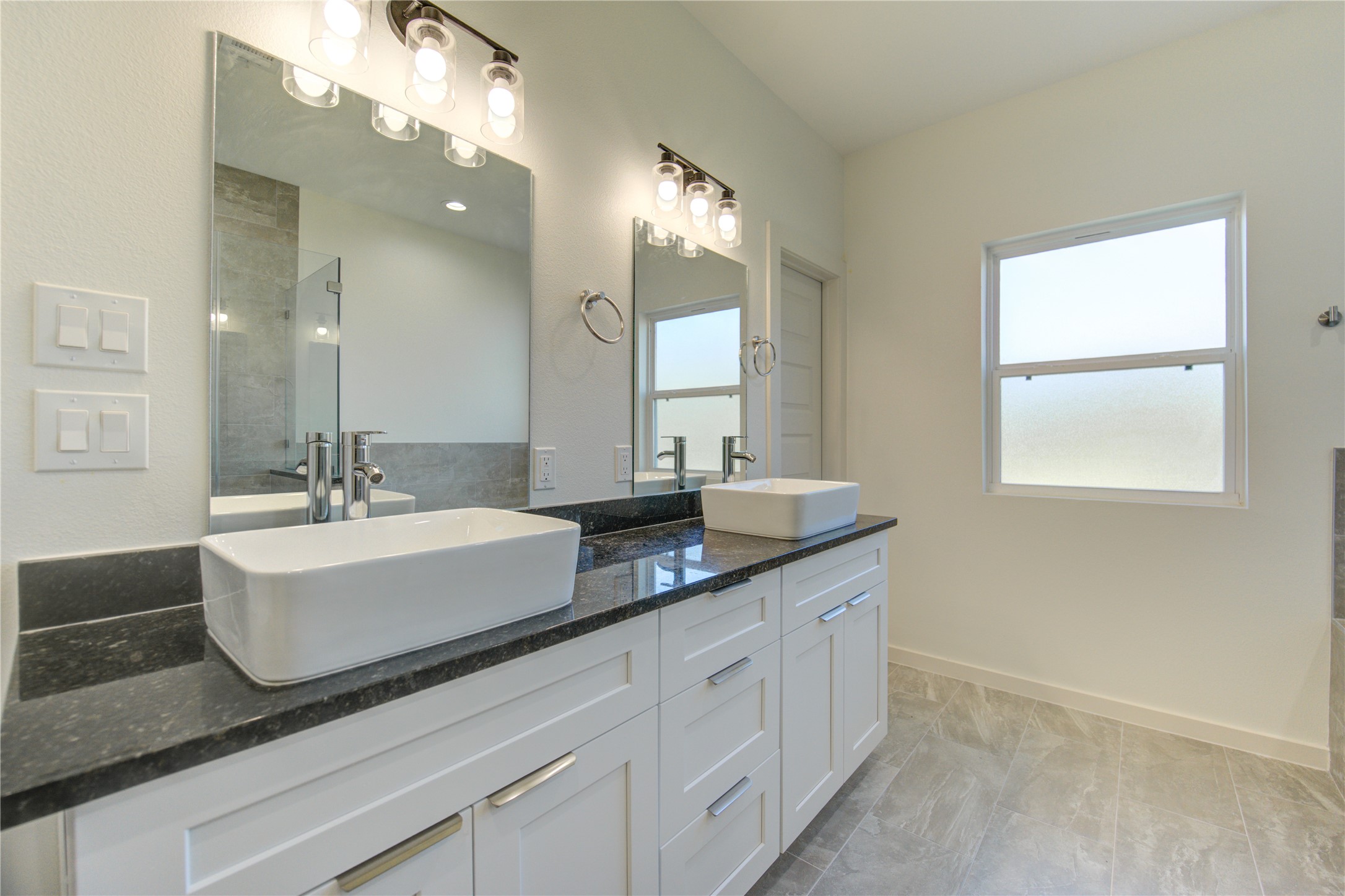 2920 El Fenice Lane Houston, TX 77057 - Photo 21 of 42 a bathroom with a sink double vanity granite and a mirror