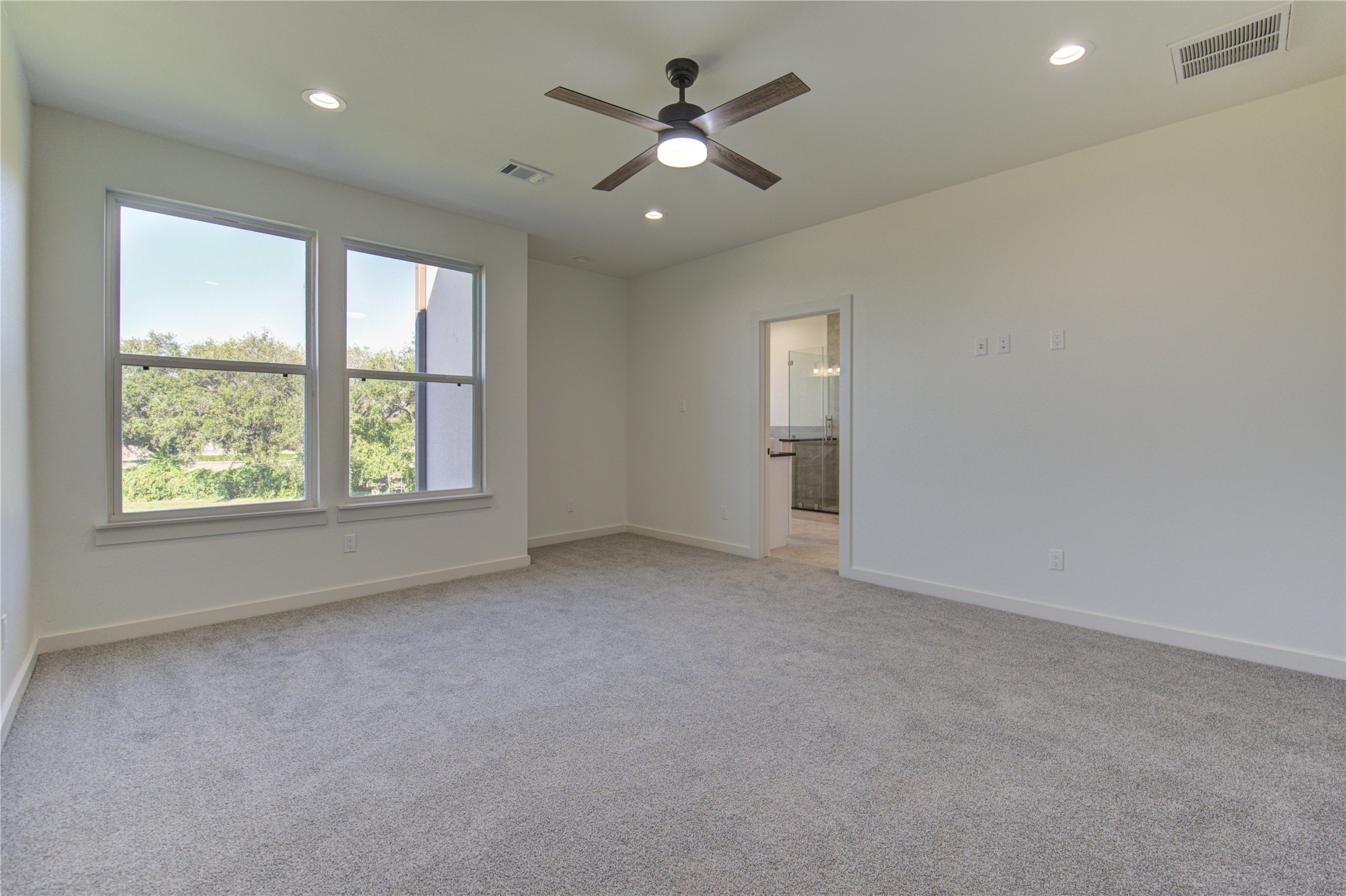 2920 El Fenice Lane Houston, TX 77057 - Photo 24 of 42 an empty room with chandelier fan and windows